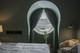 Christopher Farr Cloth Chiselled wallpaper in Moss on the walls of a bedroom and hotel